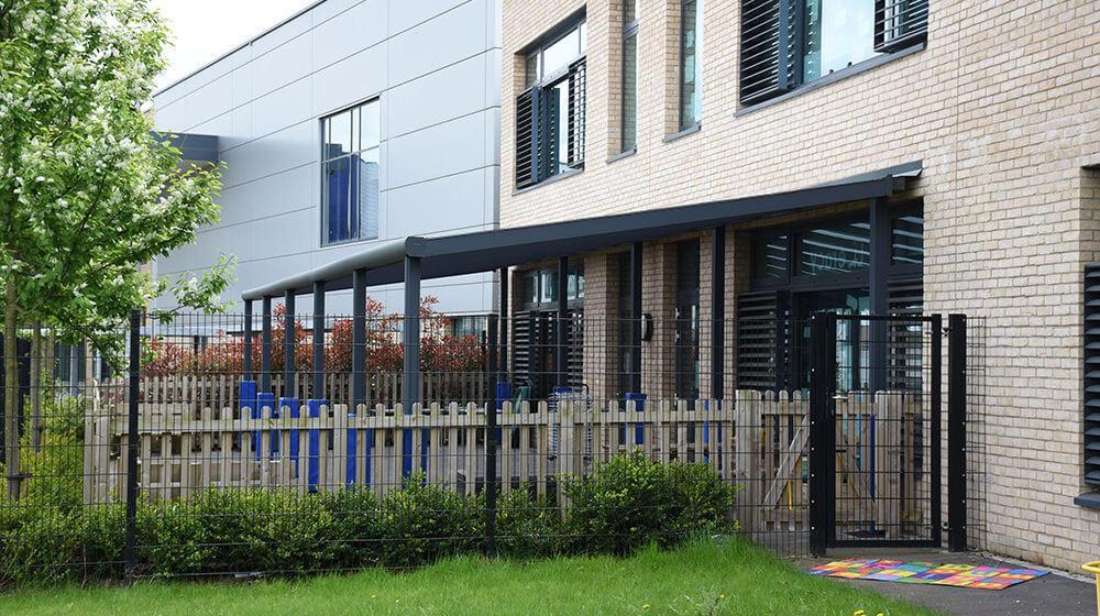 A wide shot of the aluminium lean-to canopy at Berryfields school