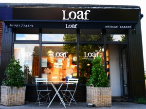 The front of one of Loaf Bakery's Farnham shops with a black branded awning.