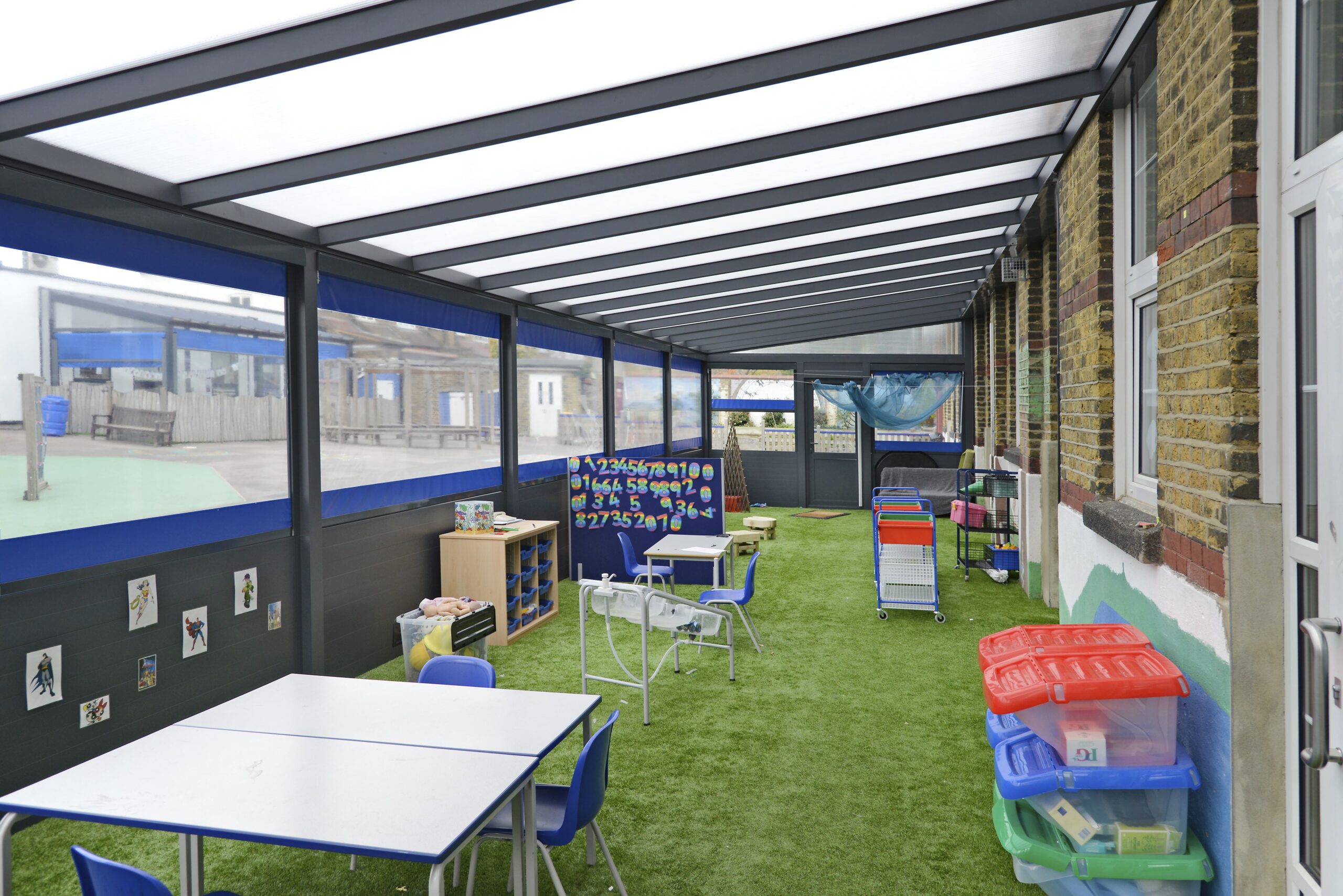 A view from inside the lean-to canopy at Childs Hill School with the canopy zip blinds down