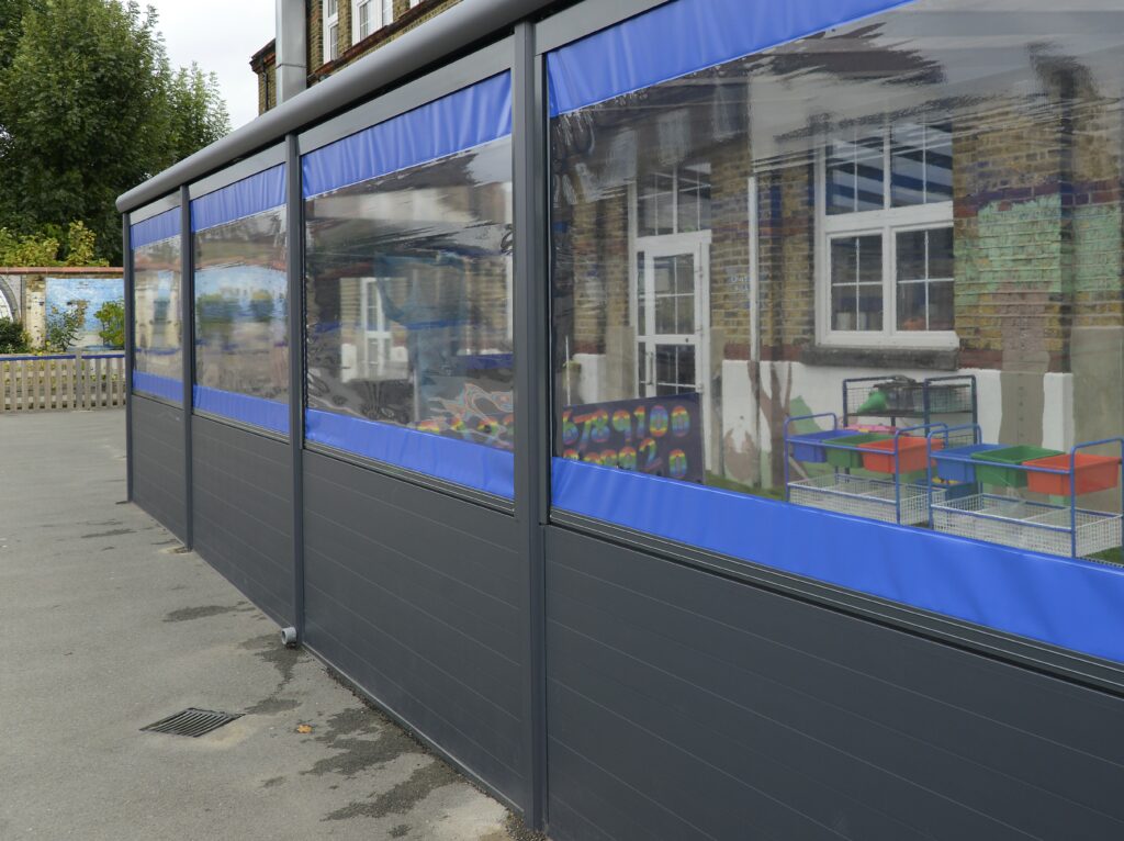 Blue and black cnopy zip blinds at Childs Hill School