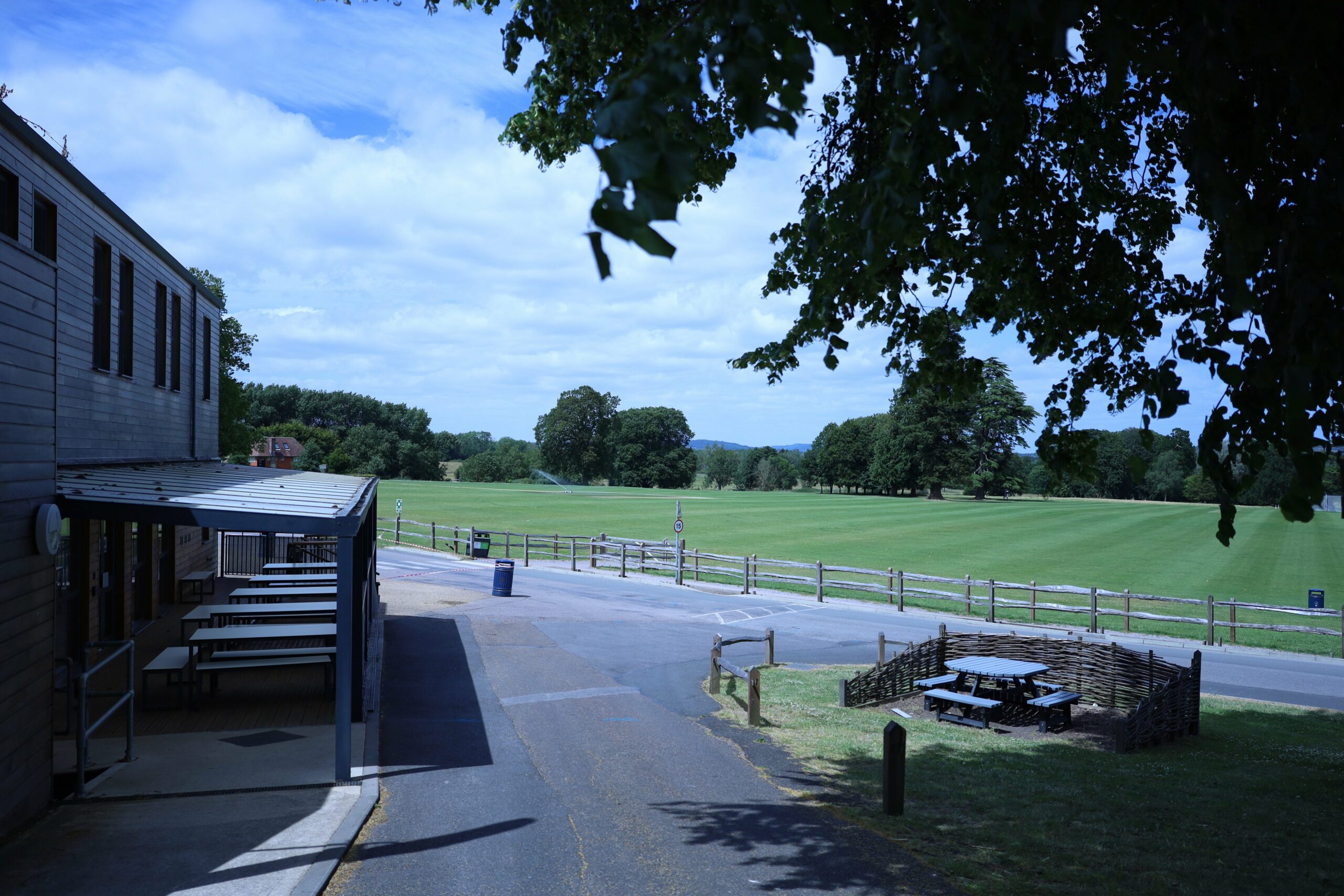 Our grey Lean-to canopy shading the decked dining area outside a cafe at Seaford College, overlooking the cricket green.