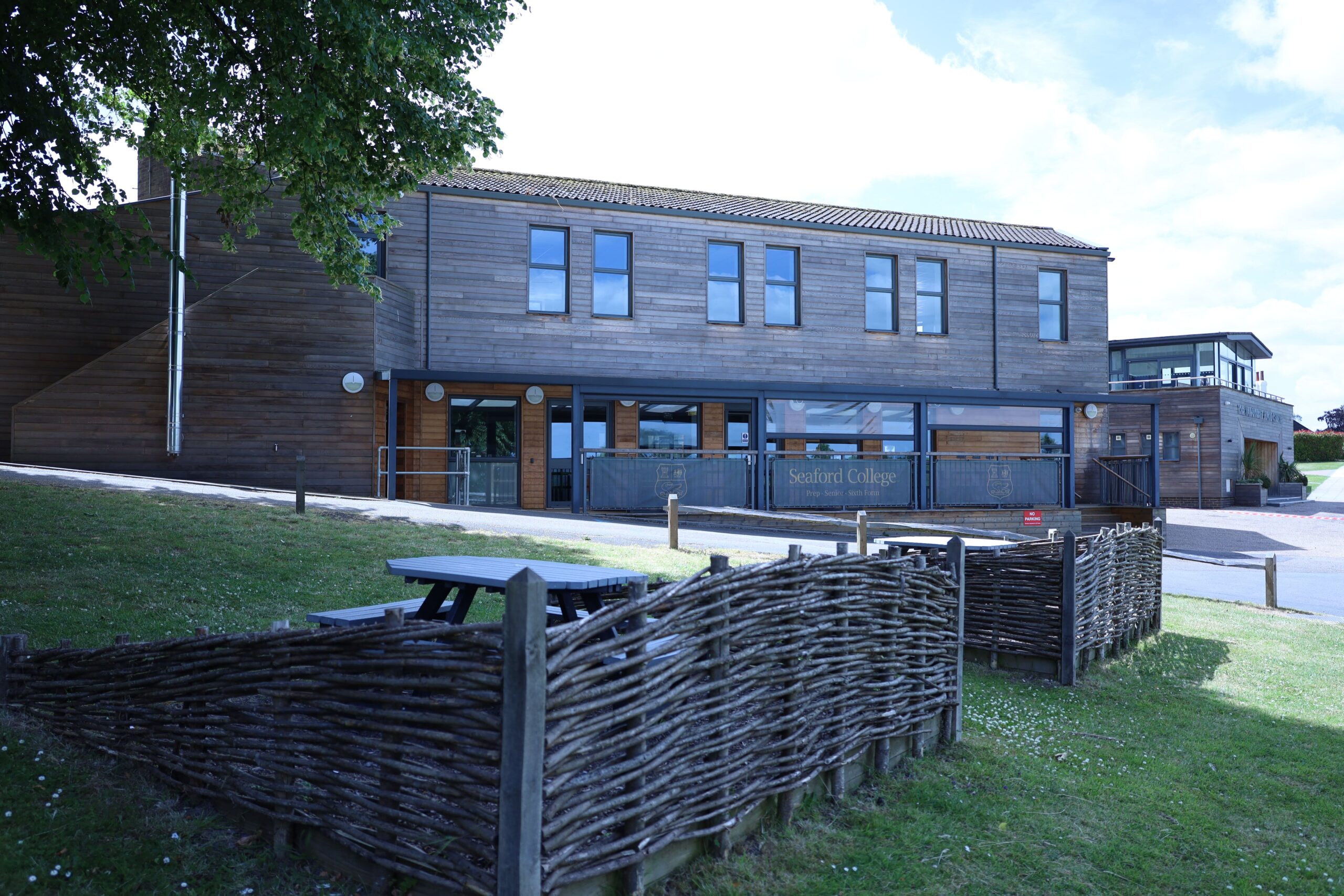 The outdoor picnic area at Seaford College with our Lean-to canopy in the background shading the decked dining space